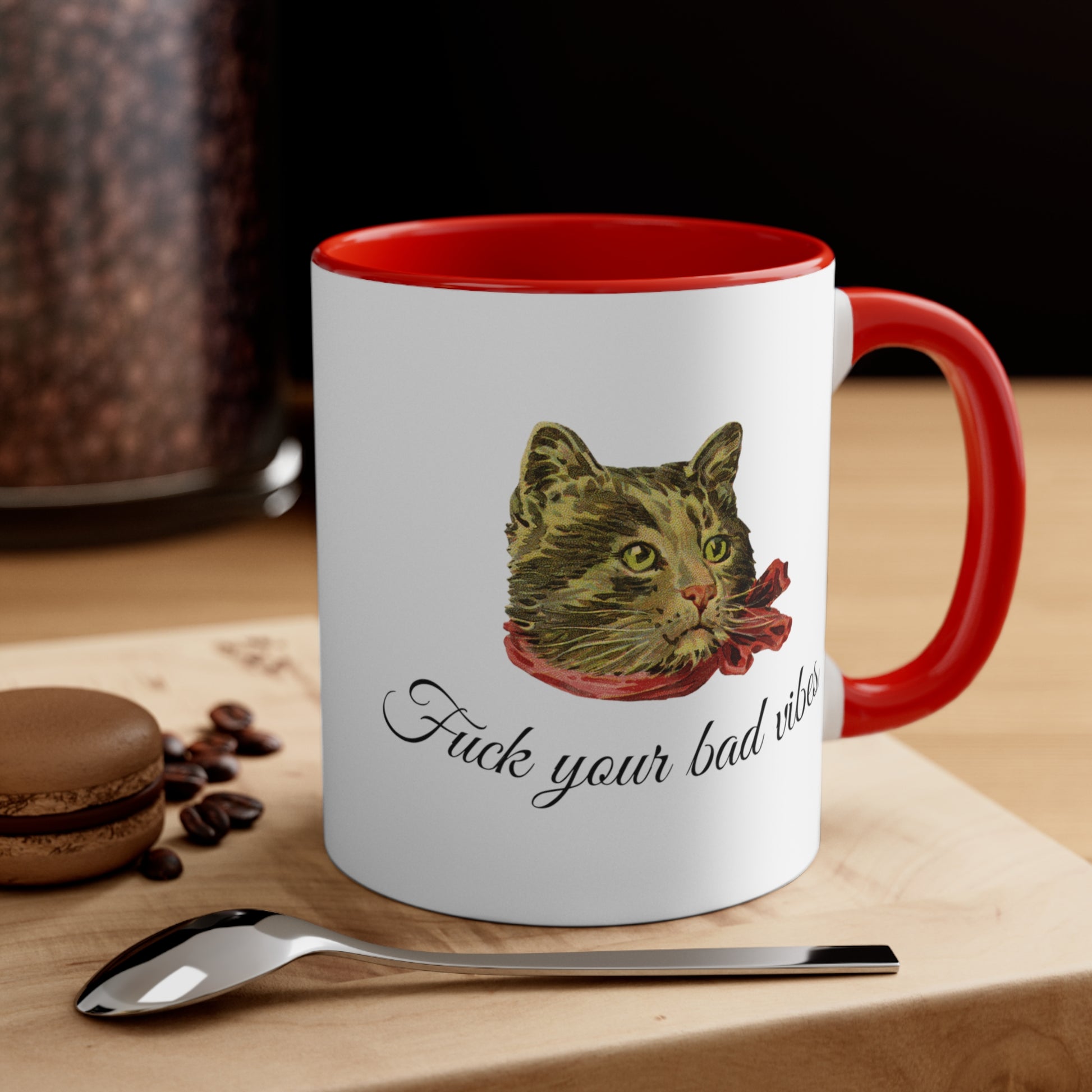 white and red mug featuring the phrase "Fuck Your Bad Vibes" in elegant cursive beneath a charming vintage graphic of a stylish cat sporting a scarf