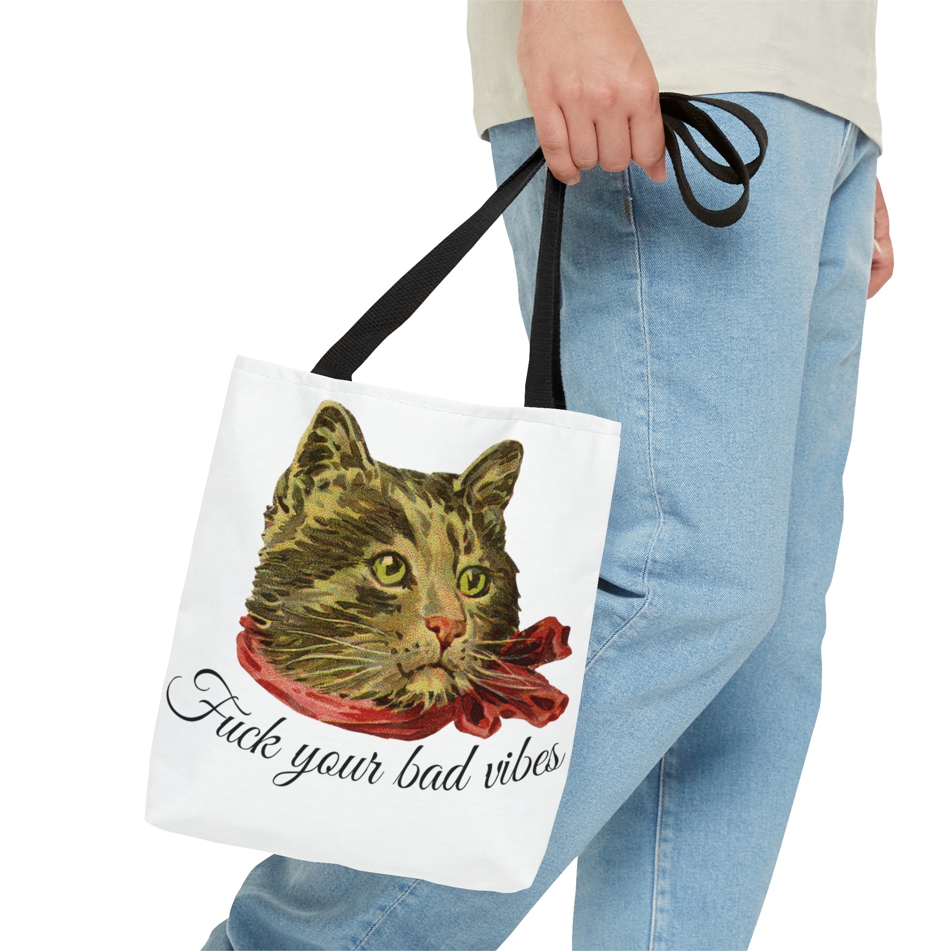 person with tote bag featuring the phrase "Fuck Your Bad Vibes" in elegant cursive beneath a charming vintage graphic of a stylish cat sporting a scarf