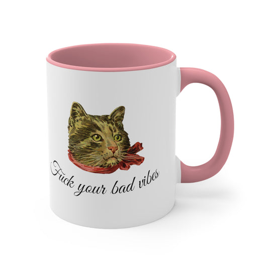 white and pink mug featuring the phrase "Fuck Your Bad Vibes" in elegant cursive beneath a charming vintage graphic of a stylish cat sporting a scarf