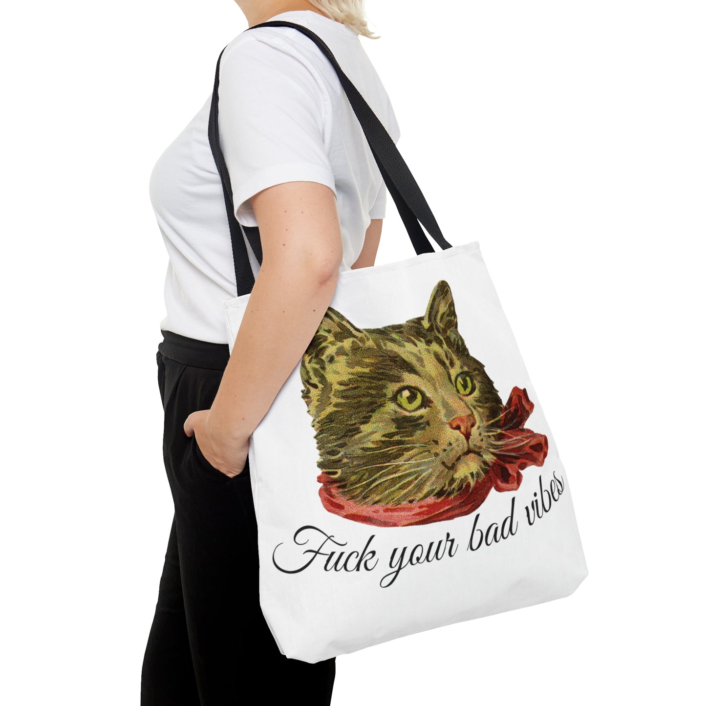 woman with tote bag featuring the phrase "Fuck Your Bad Vibes" in elegant cursive beneath a charming vintage graphic of a stylish cat sporting a scarf