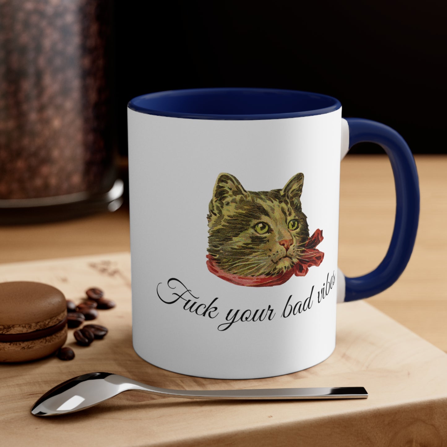 white and dark blue mug featuring the phrase "Fuck Your Bad Vibes" in elegant cursive beneath a charming vintage graphic of a stylish cat sporting a scarf